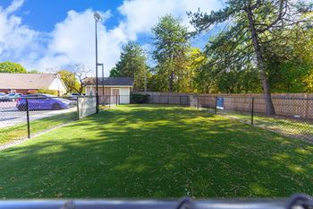 A fenced green bark park
